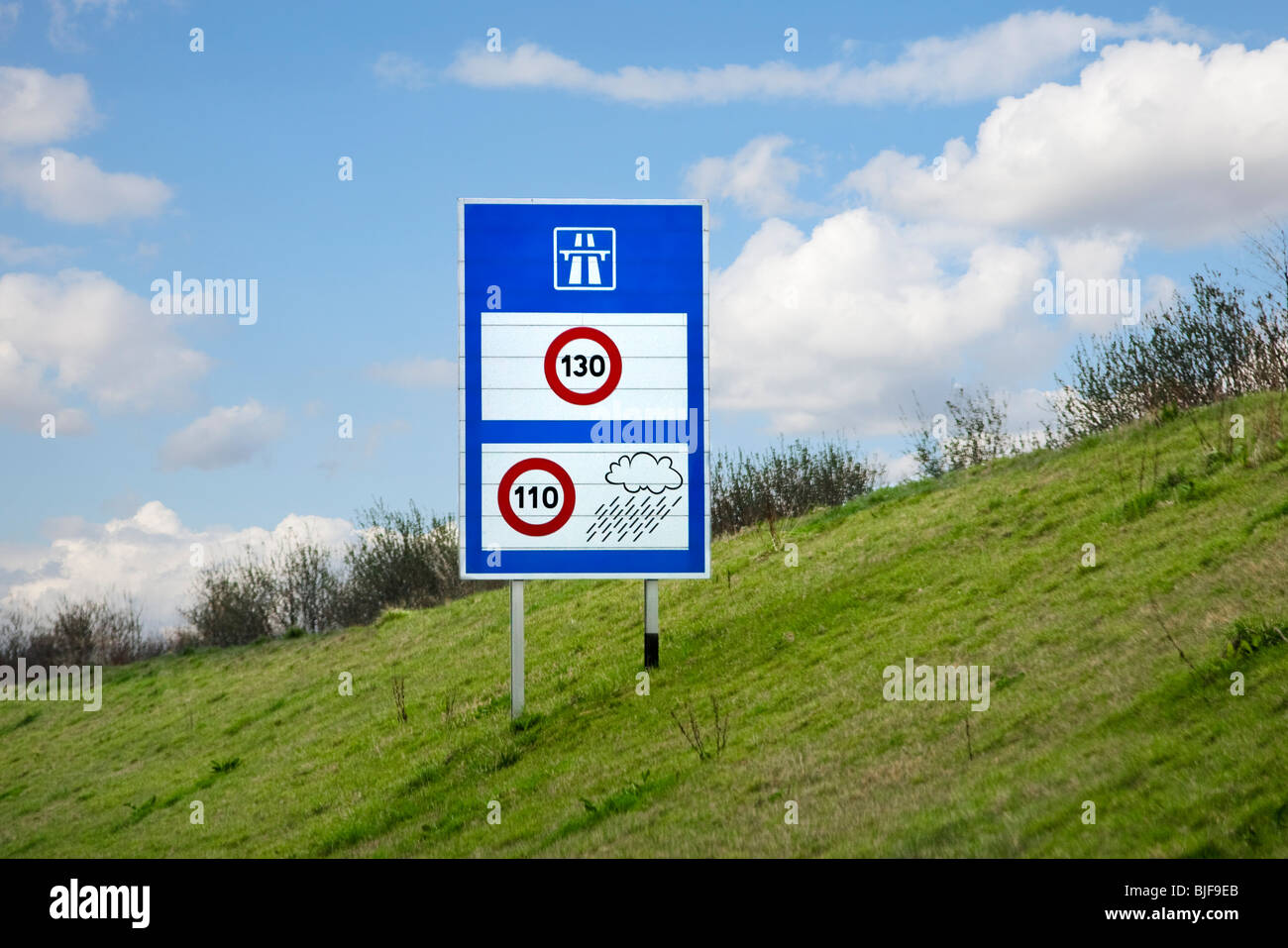 French autoroute motorway speed limit sign showing weather restrictions on speed limits, France, Europe Stock Photo