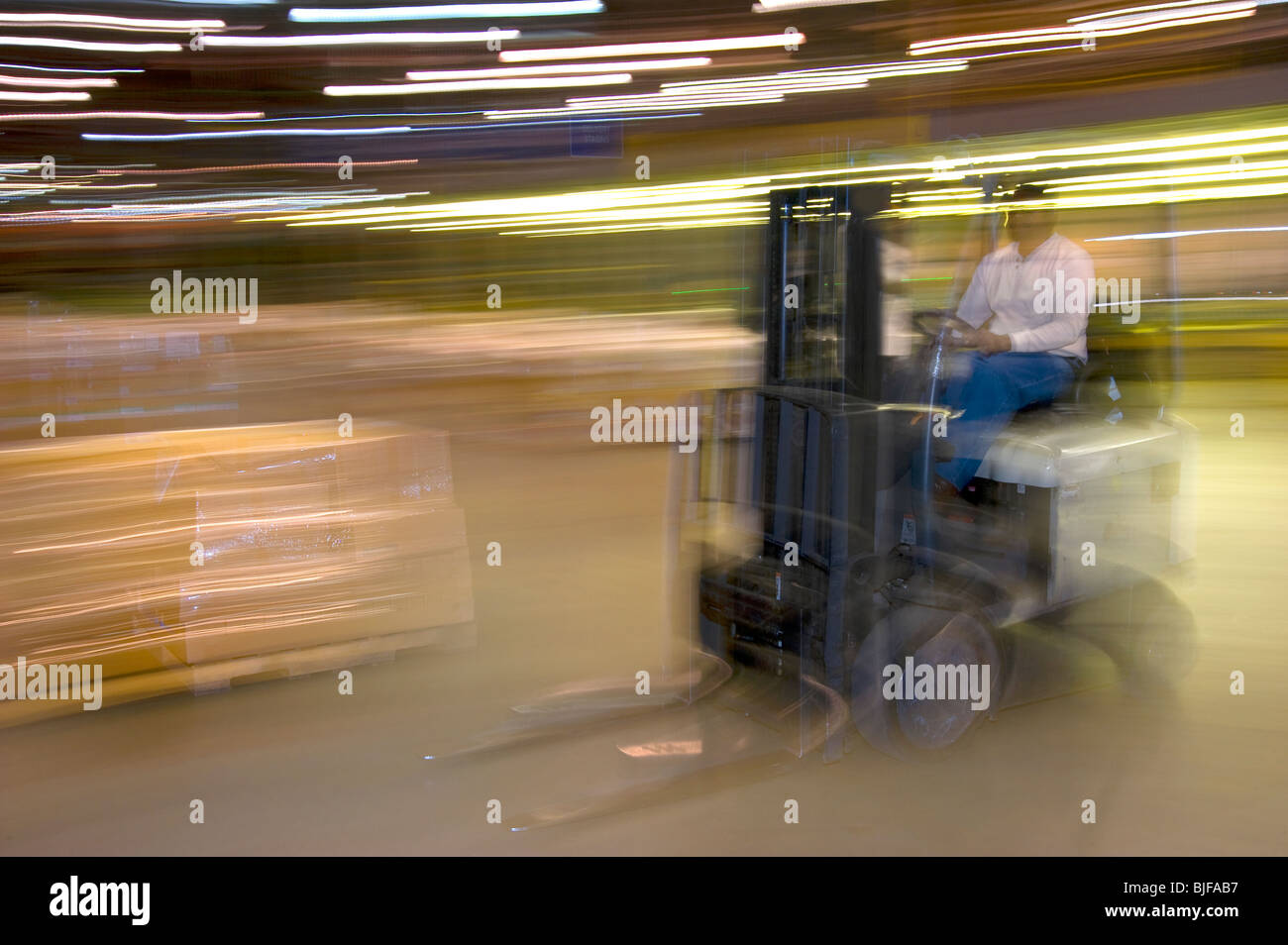 Warehouse Worker On Forklift Moving Boxes, Philadelphia, USA Stock Photo