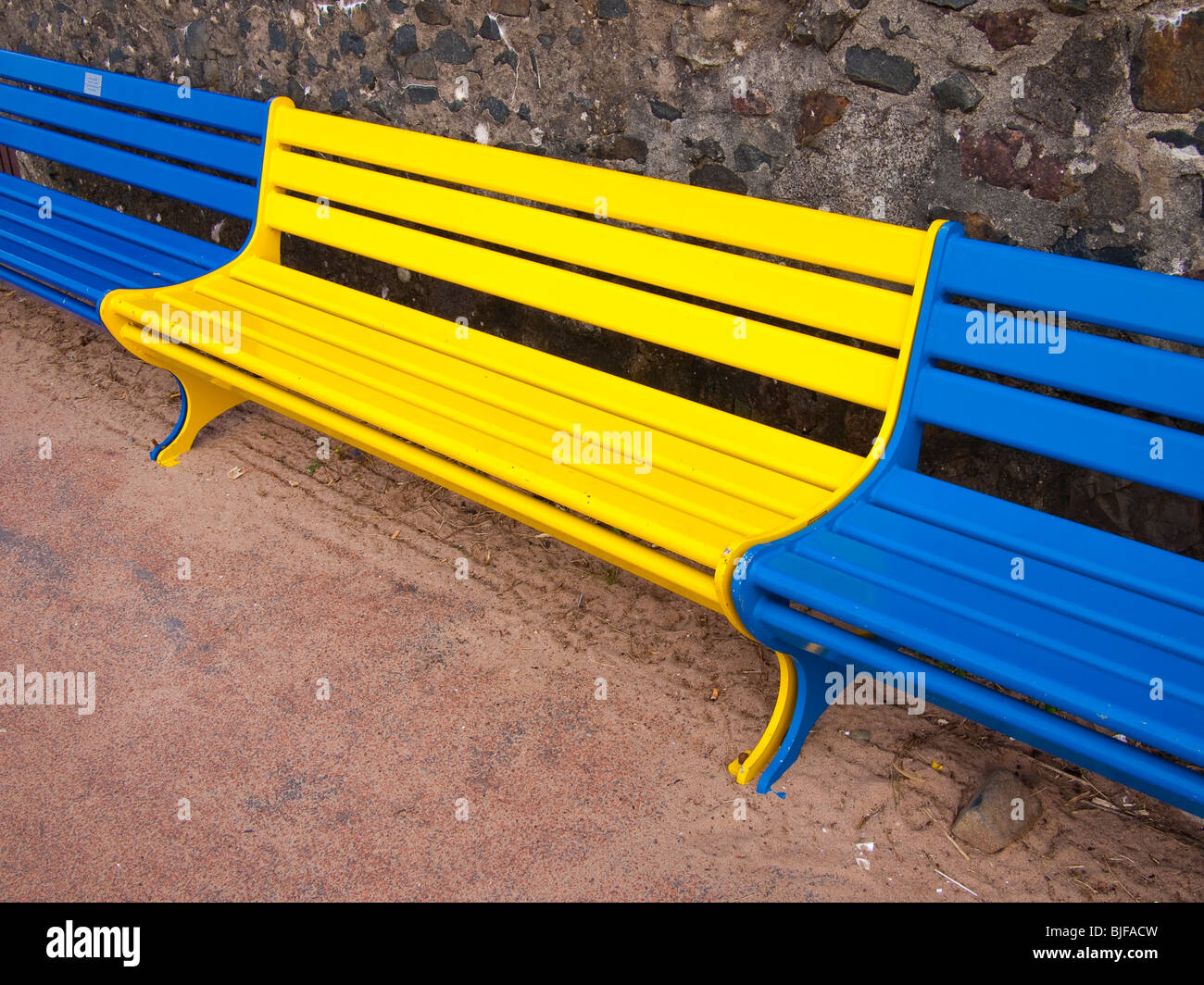 Blue and Yellow Park Benches Stock Photo