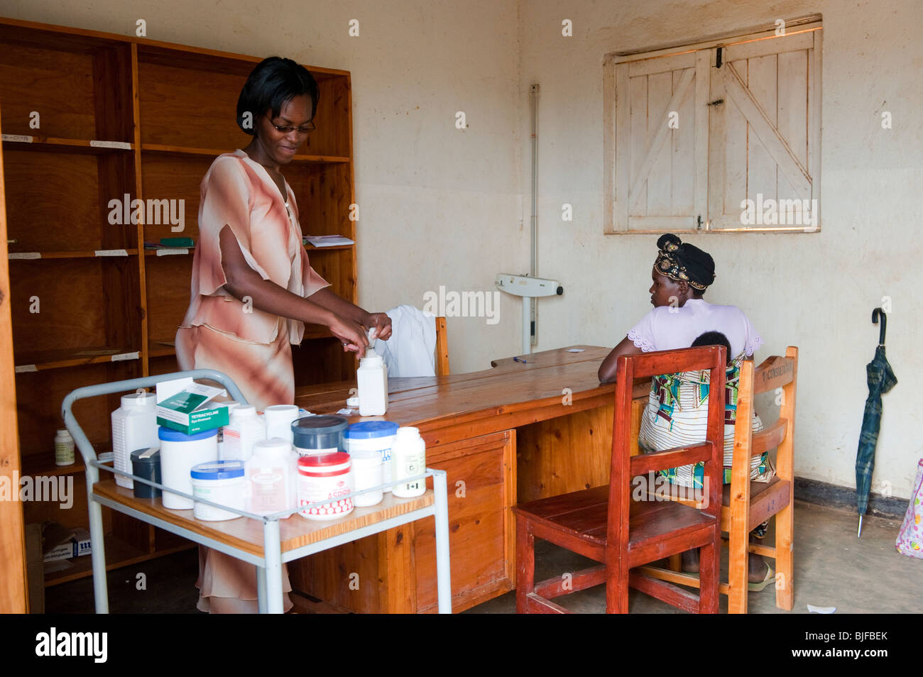 Doctor in Rwandan dispensary providing medicine to a patient. Rwanda Stock Photo