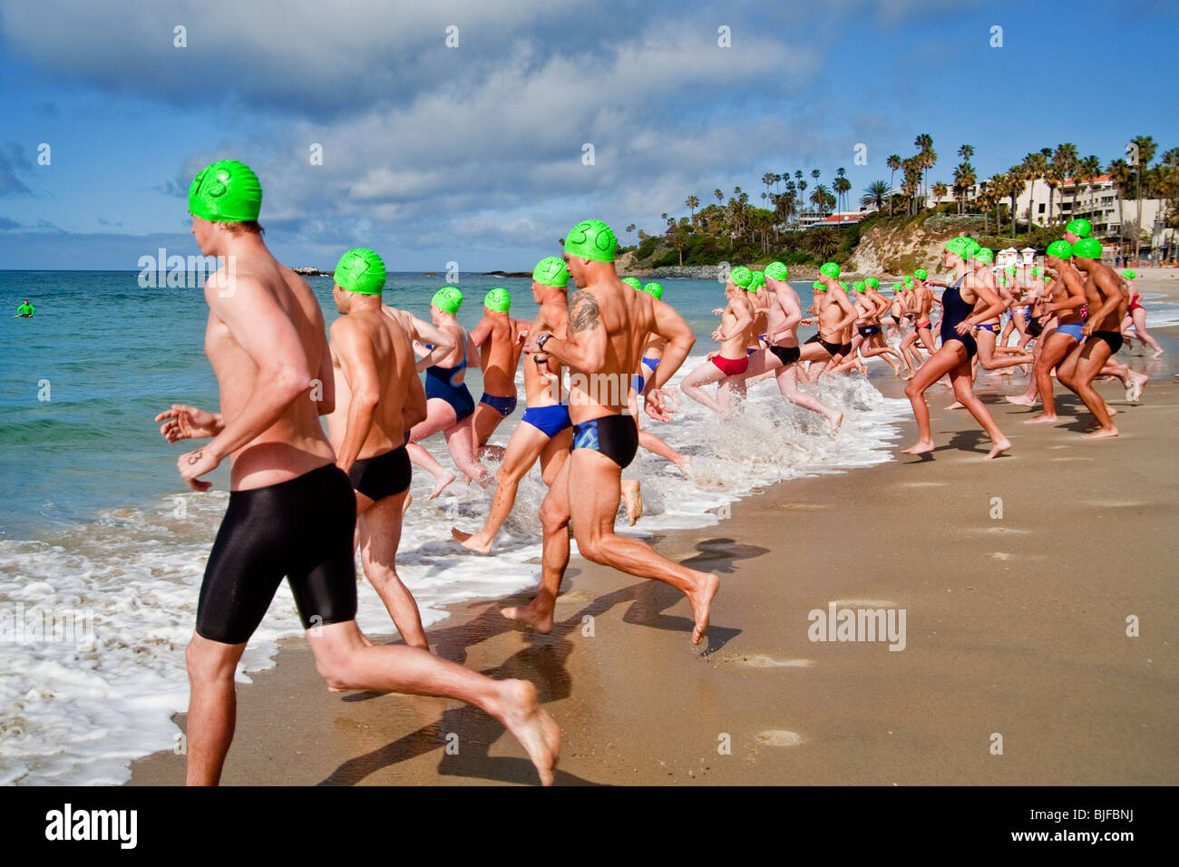 Wearing caps with their classification numbers, teen applicants for  lifeguard jobs race to start long-distance qualifying swim Stock Photo -  Alamy