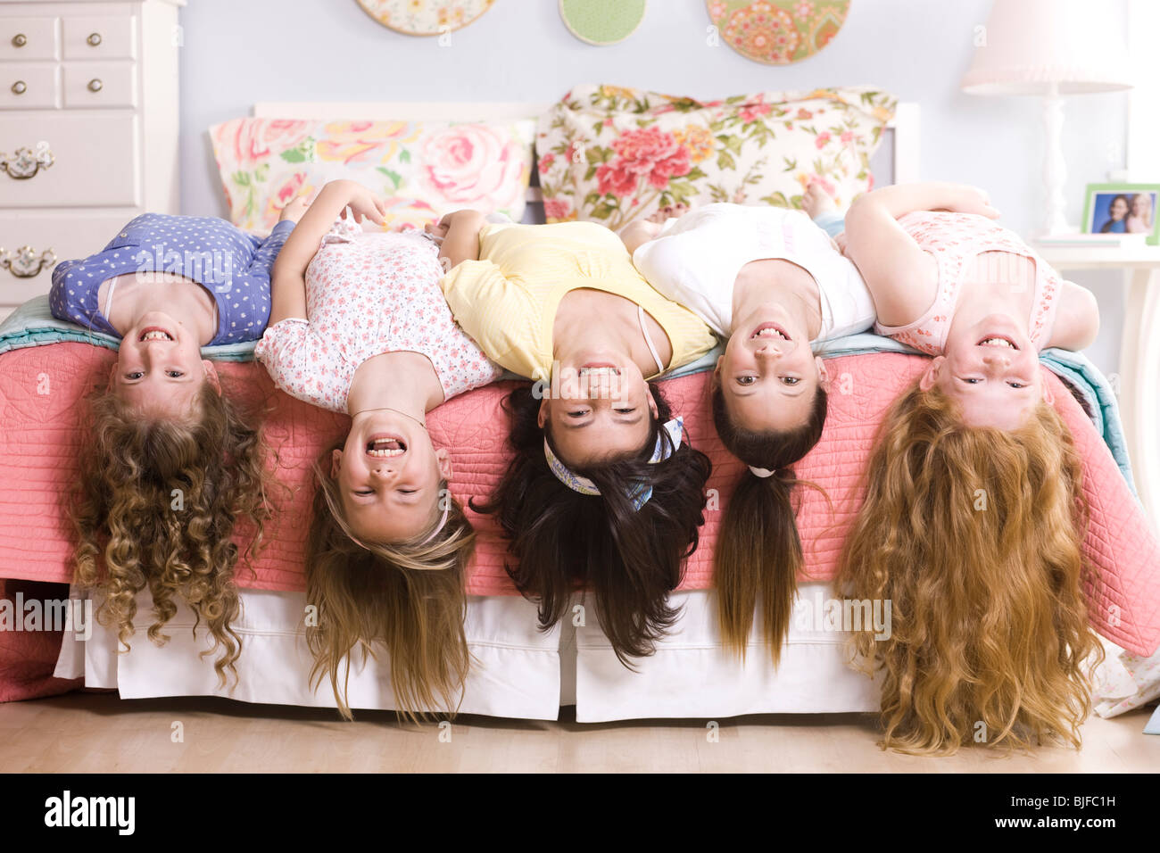 five girls on a bed upside down Stock Photo Alamy