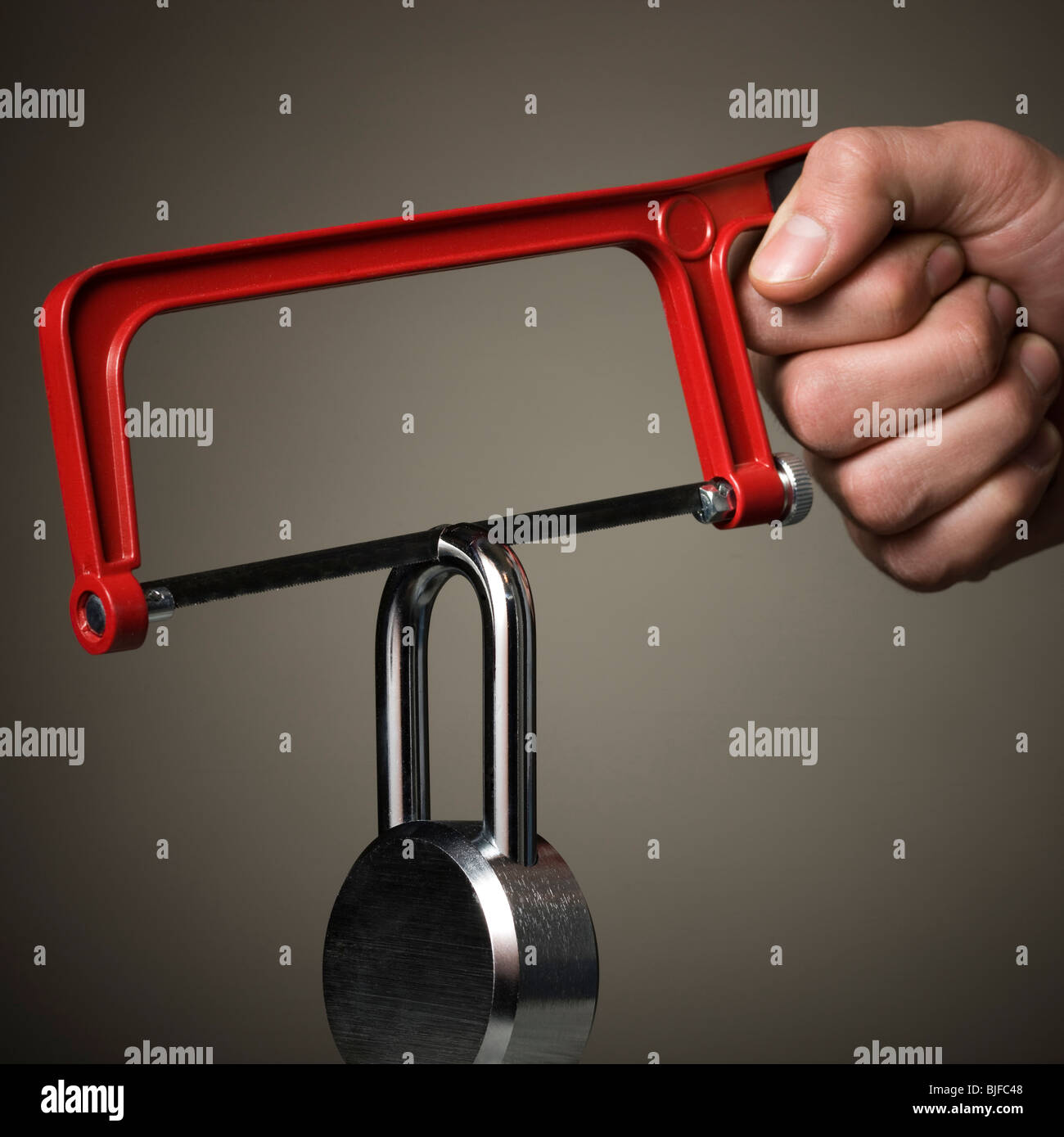 hacksaw cutting a padlock Stock Photo