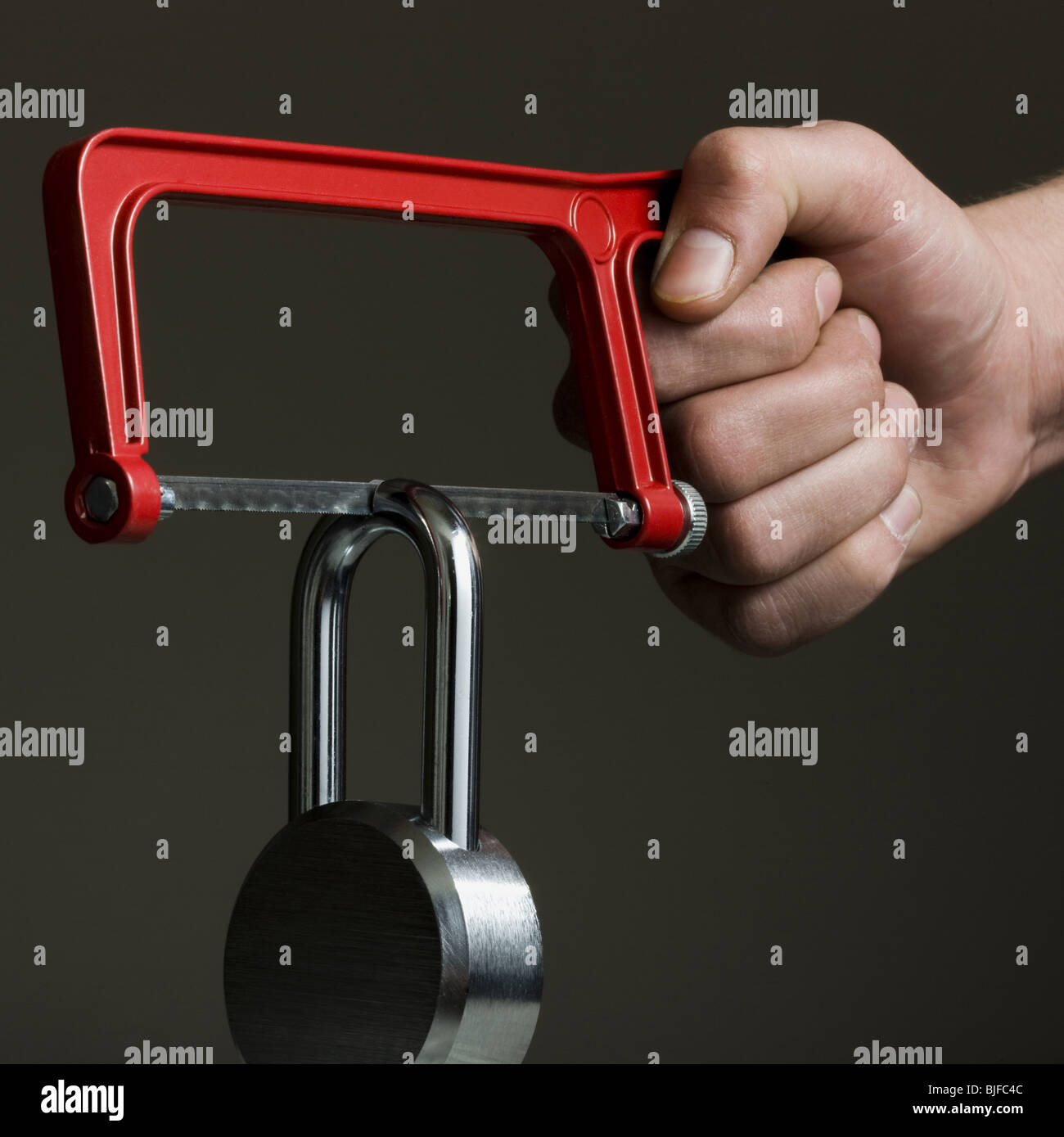 hacksaw cutting a padlock Stock Photo