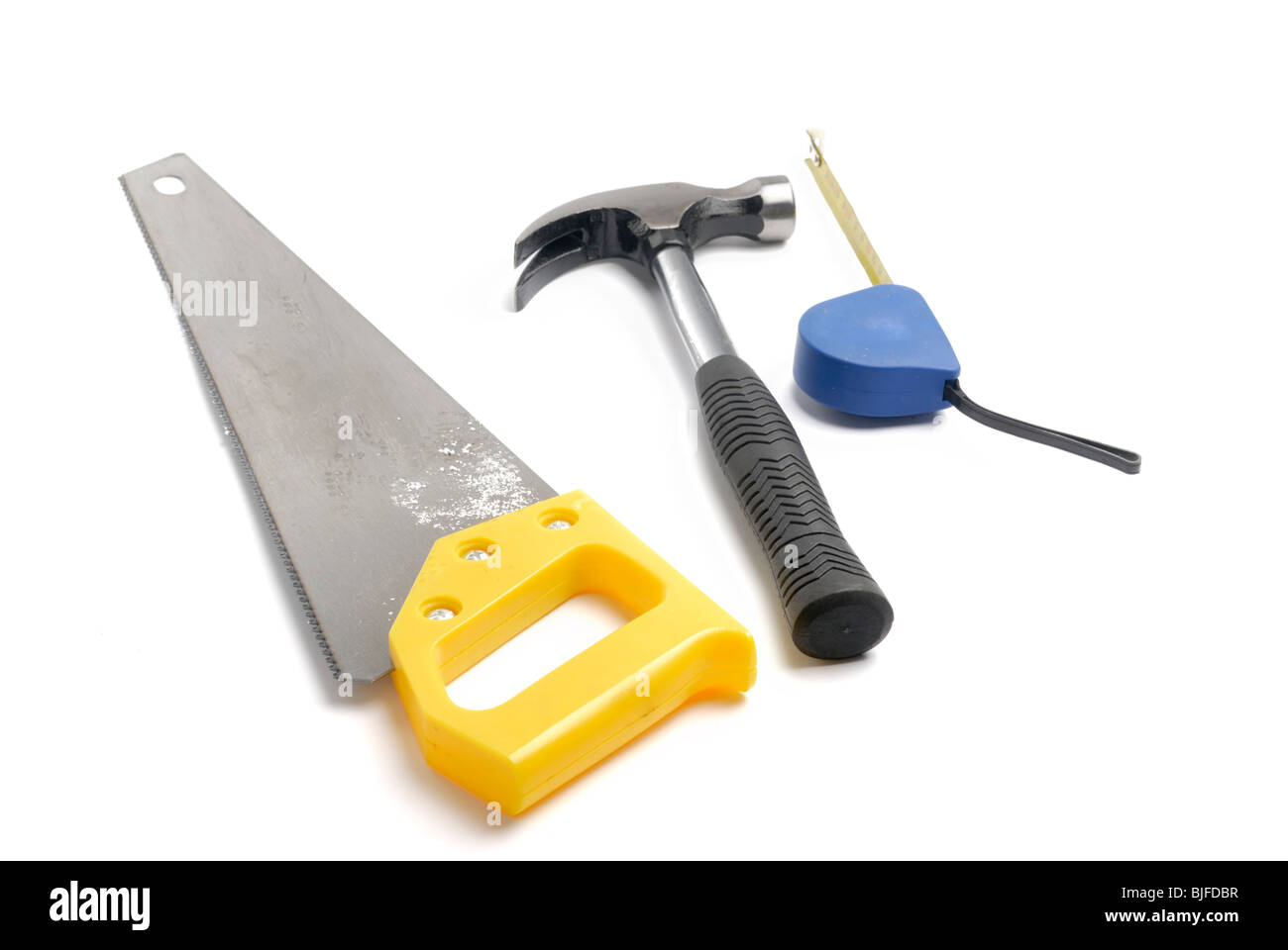 Tape measure, hammer and saw Stock Photo