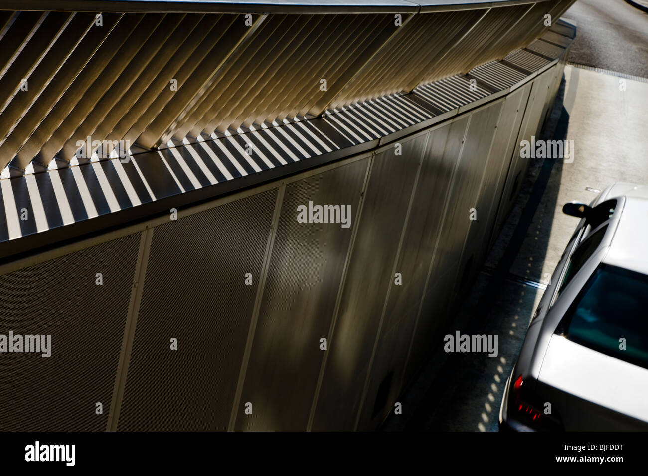Car driving out of underground parking garage rear elevated view