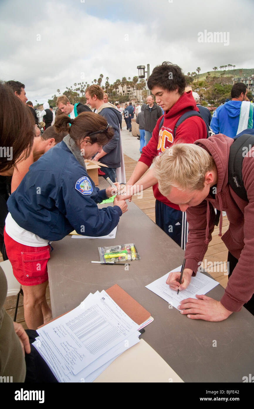 Teenagers of both sexes line up to apply for spring tryouts for summer lifeguard jobs in Laguna Beach, California. Stock Photo