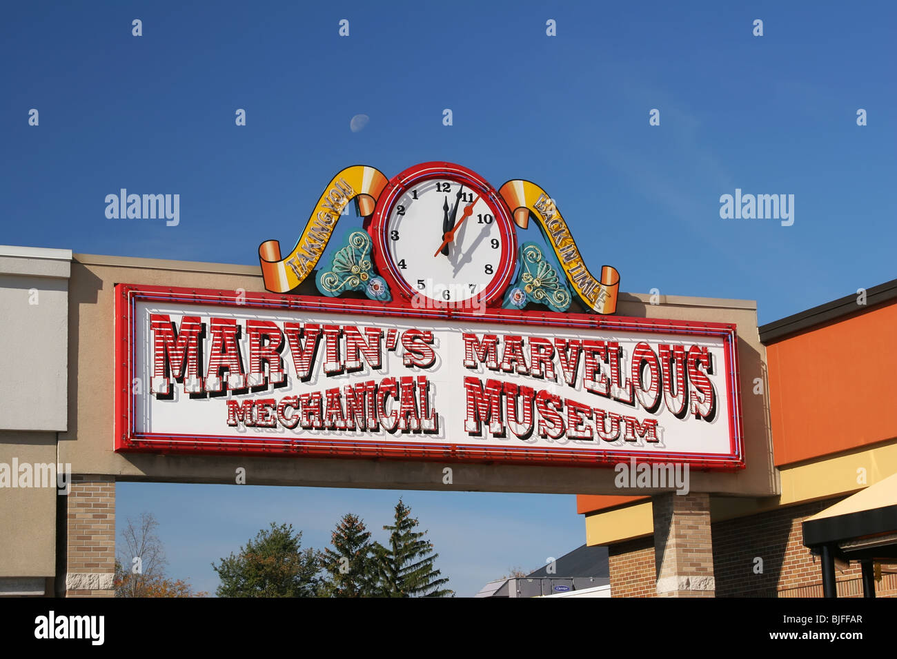 Sign for Marvins Marvelous Mechanical Museum in Farmington Hills, Michigan, USA. Note reverse running clock. Stock Photo