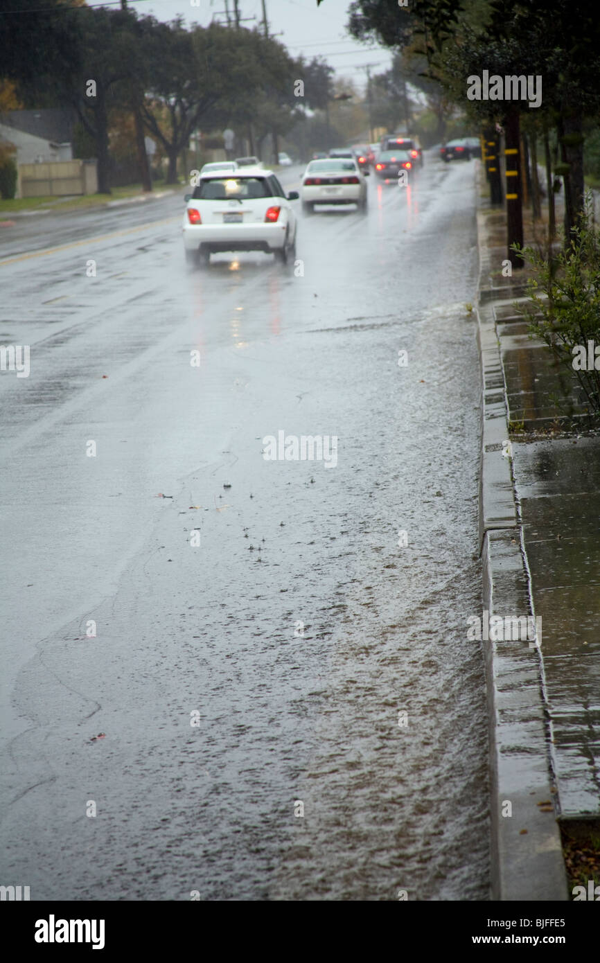 Heavy rains flow down streets into Street Gutters and Storm Drains ...