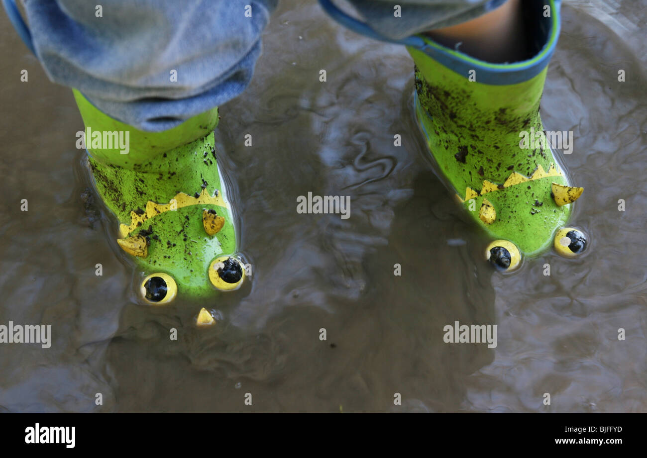 A child's rainboots in a puddle. Stock Photo
