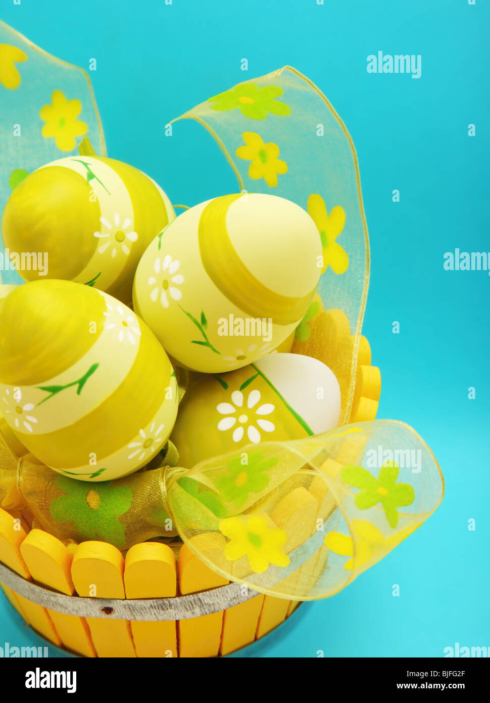 Easter eggs in the basket isolated on blue background Stock Photo - Alamy