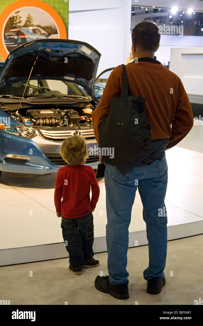 Father and son in front of Honda Insight Hybrid. Alternative Fuel Vehicles at 2009 Los Angeles Auto Show, California, USA Stock Photo