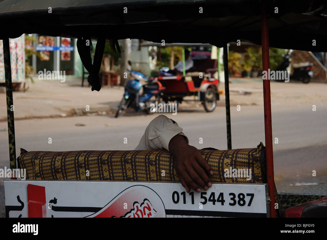 Sleeping on the job, tuk-tuk driver Siem Reap, Cambodia Stock Photo