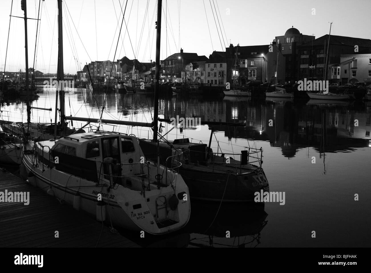 dusk black and white image weymouth harbour boats dorset england uk gb Stock Photo