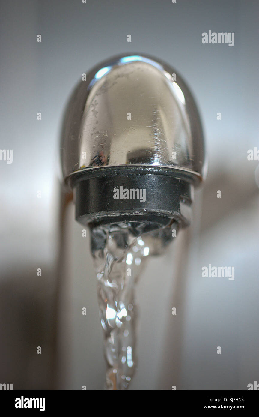 Water running from a tap. Domestic water supply, water flowing from a