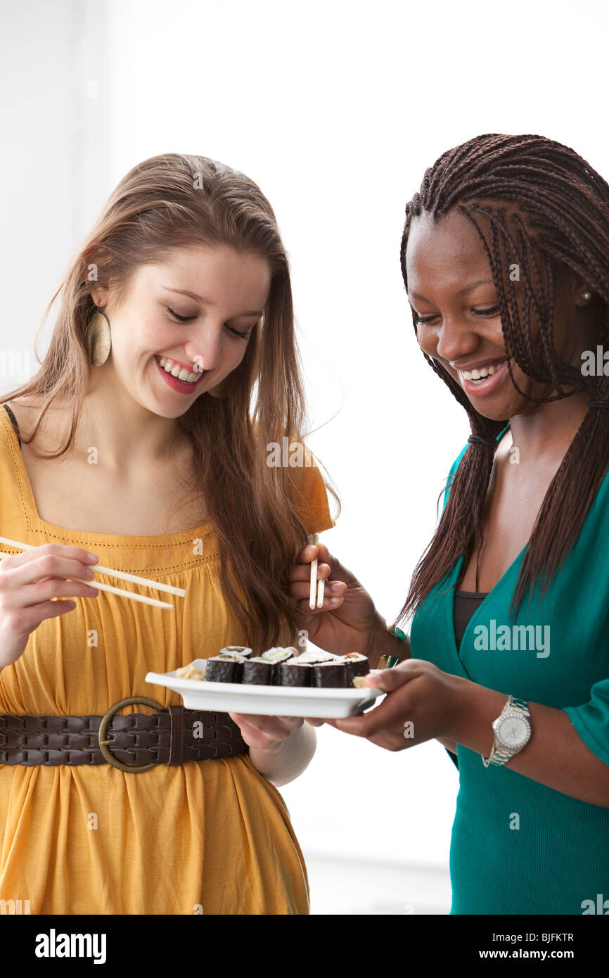 Teenage girls eating Japanese sushi Stock Photo