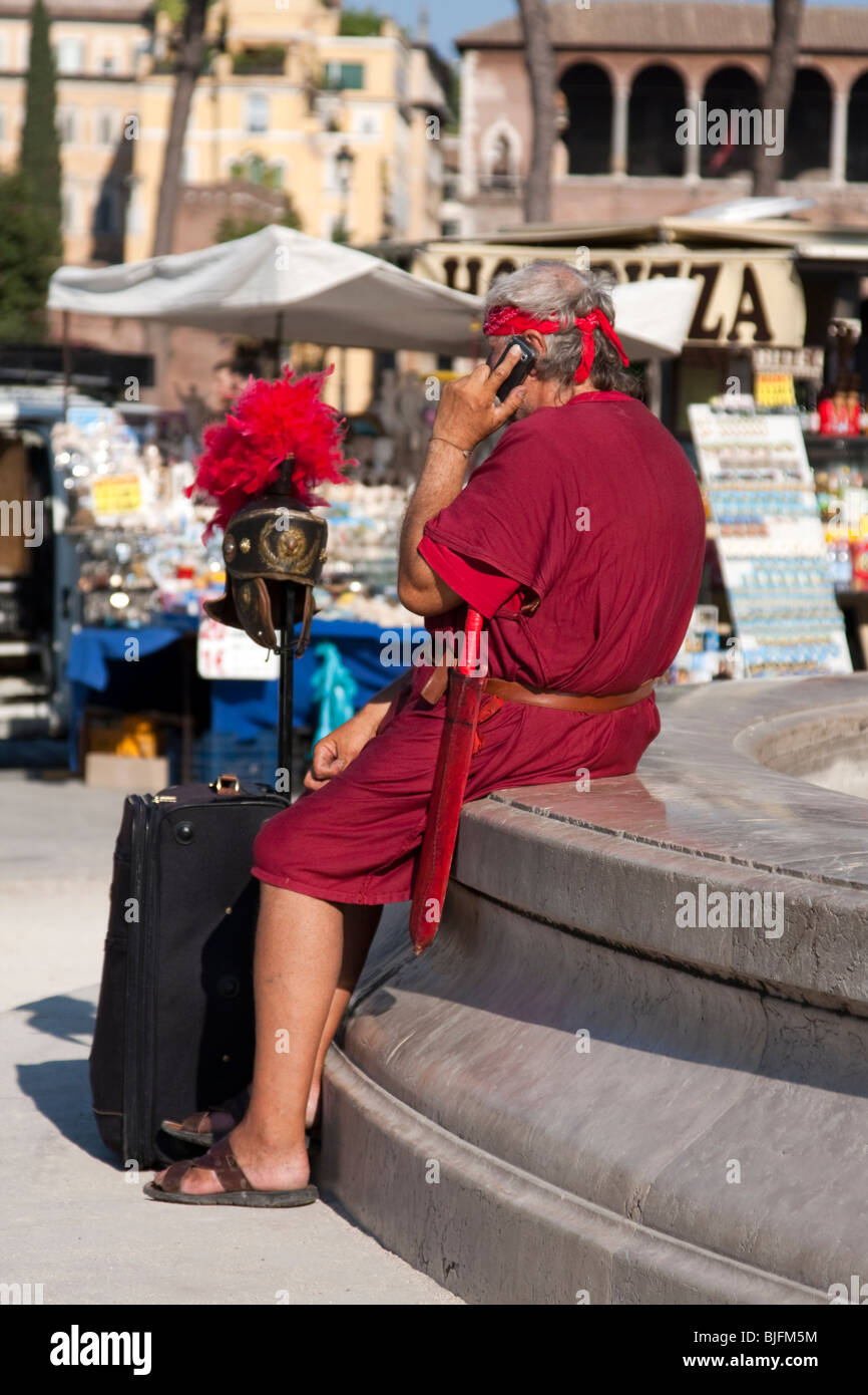 Man dressed as Roman Gladiator in the street of Rome speaking at his mobile phone. Rome, Italy Stock Photo