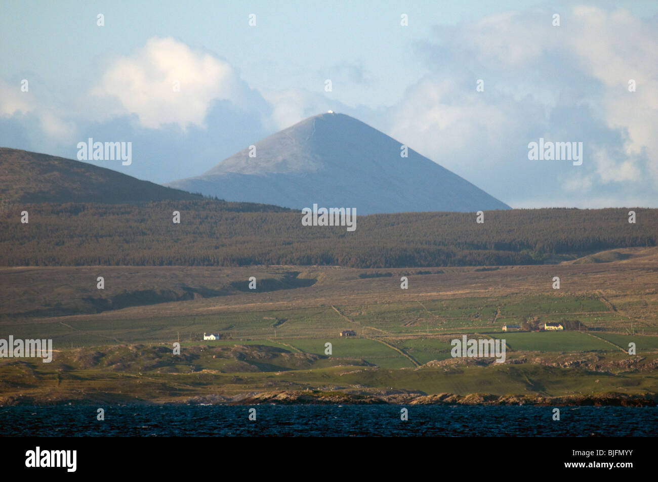 A telephoto shot of Croagh Patrick (about 27km or 16.7 miles away), from Renvyle Beach, Connemara, County Galway, Ireland Stock Photo