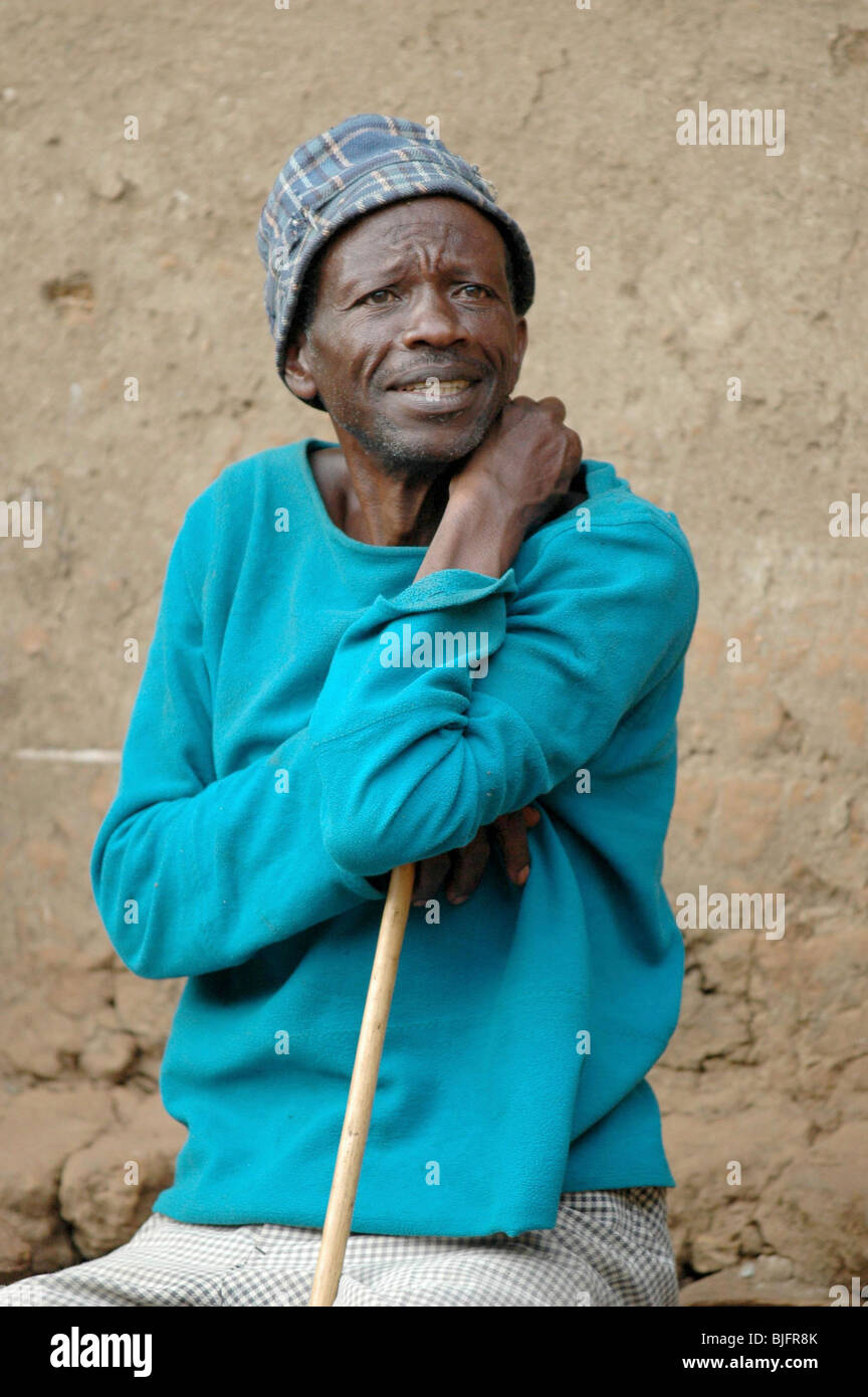 An man from the older generation watches the Pygmy dancing. Uganda, Africa © Demelza Cloke Stock Photo