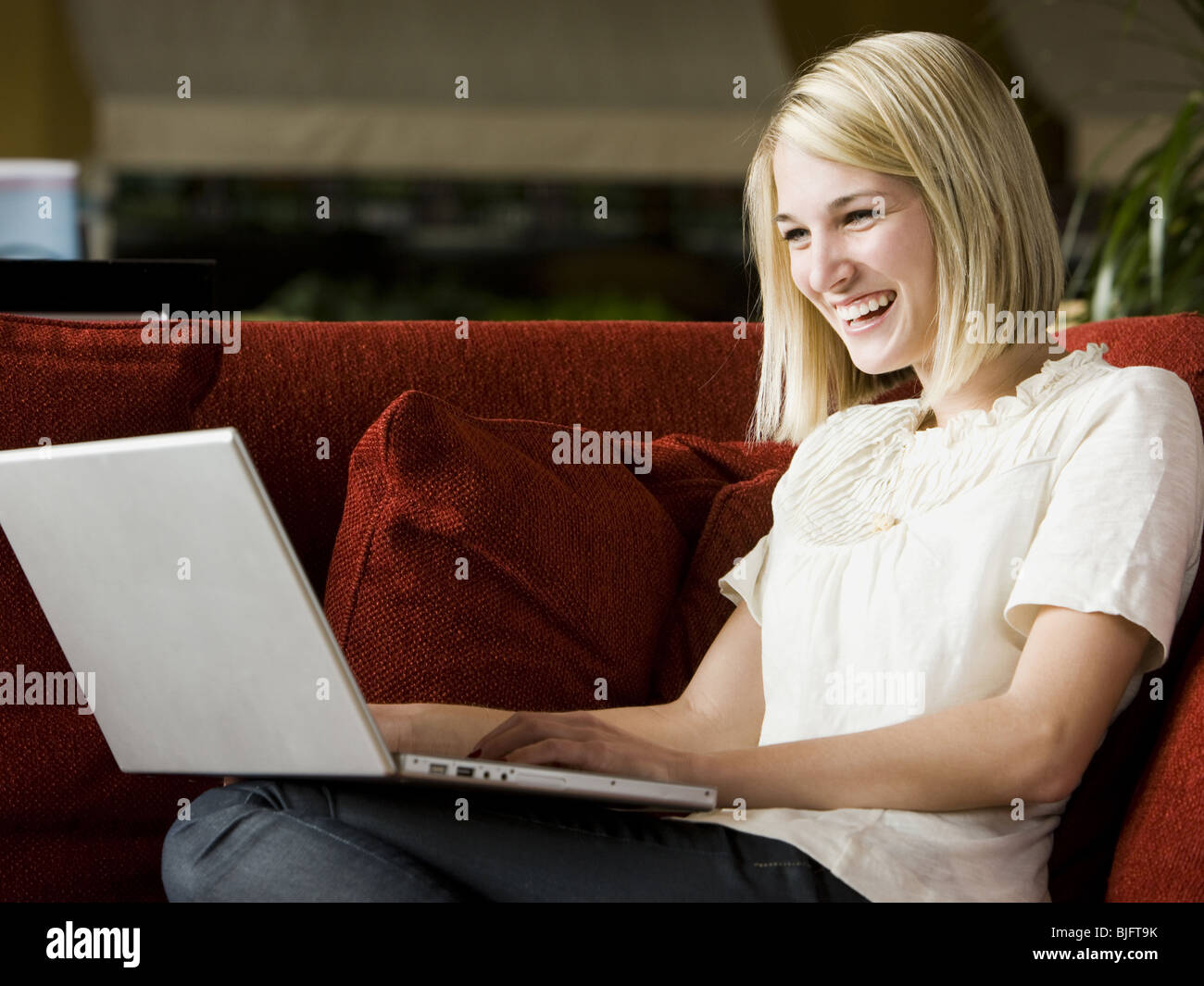 woman using laptop on the couch Stock Photo
