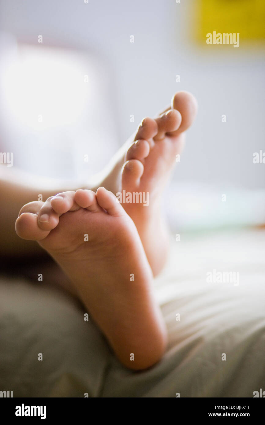 bare feet hanging off the bed Stock Photo Alamy
