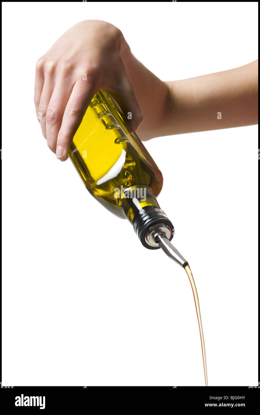 hand pouring olive oil Stock Photo