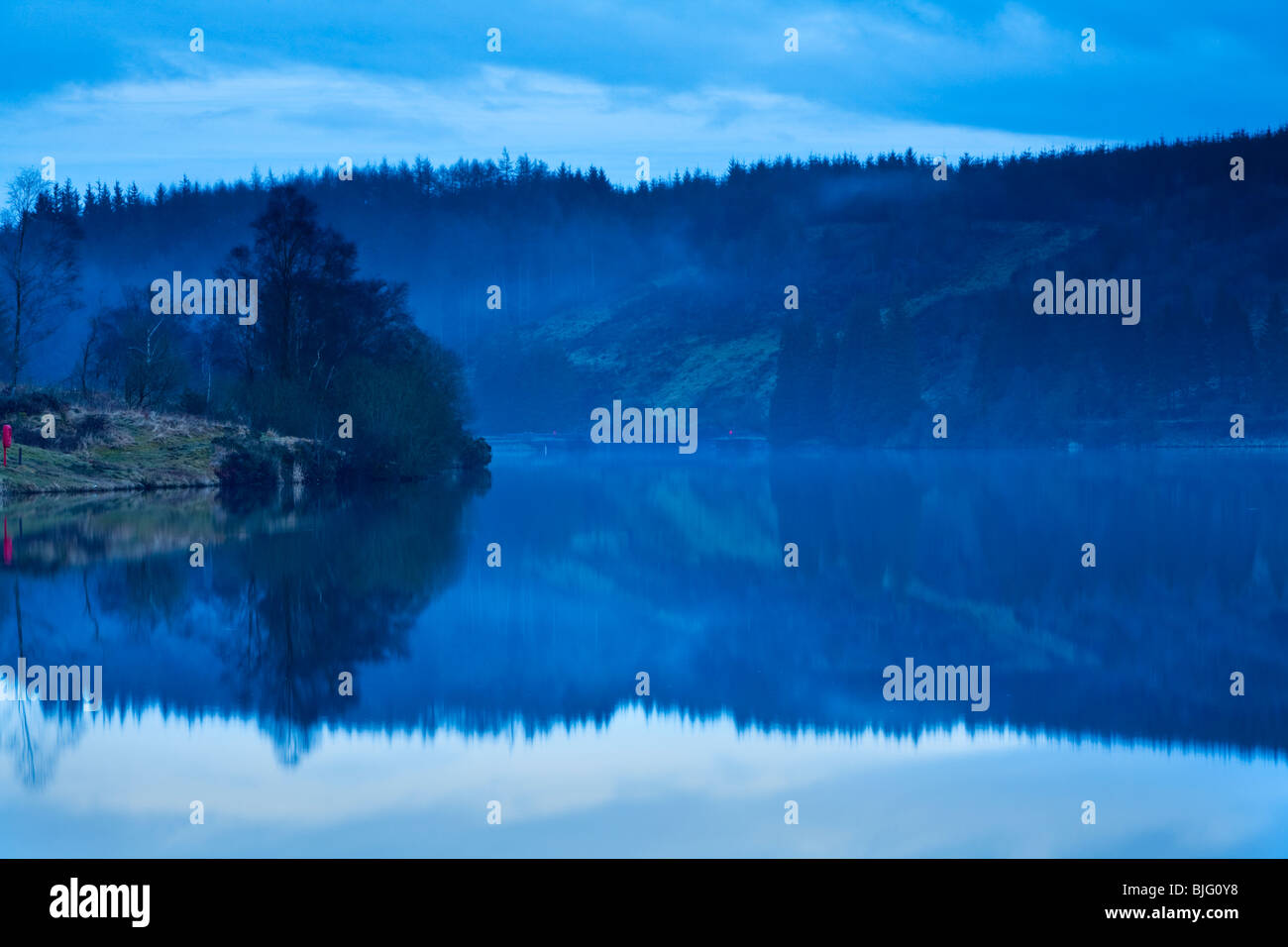 Dusk reflections on the surface of Beacons Reservoir in the Brecon Beacons, Powys, Wales, Uk Stock Photo