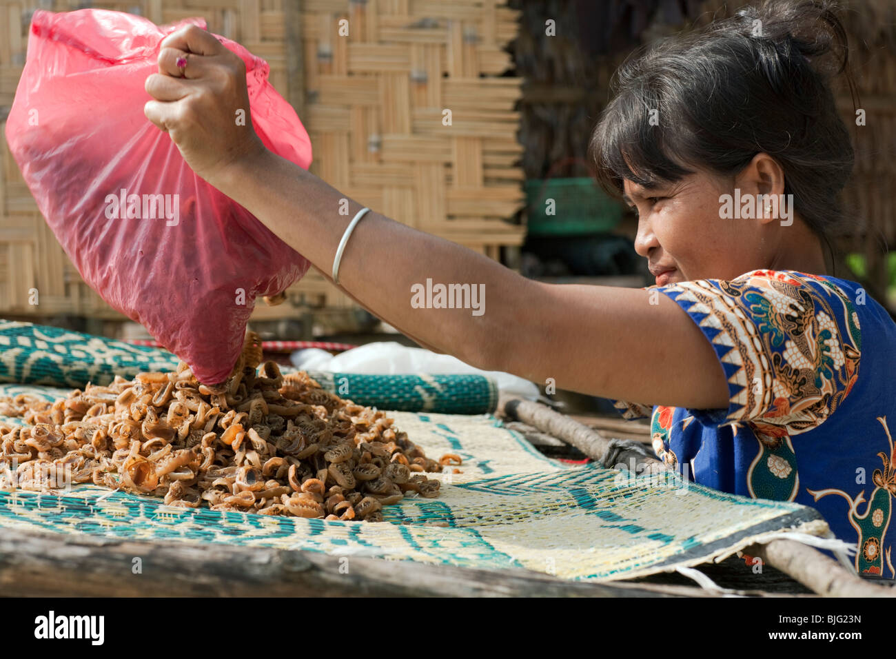 Myanmar sea-gypsies, the nomadic hunter-gatherers of South East Asia displaying her wares at a market Stock Photo