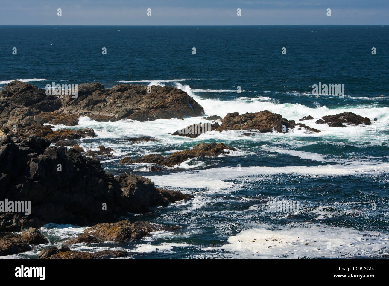 Waves breaking over the rocky coast of Vancouver Island, British Columbia Stock Photo