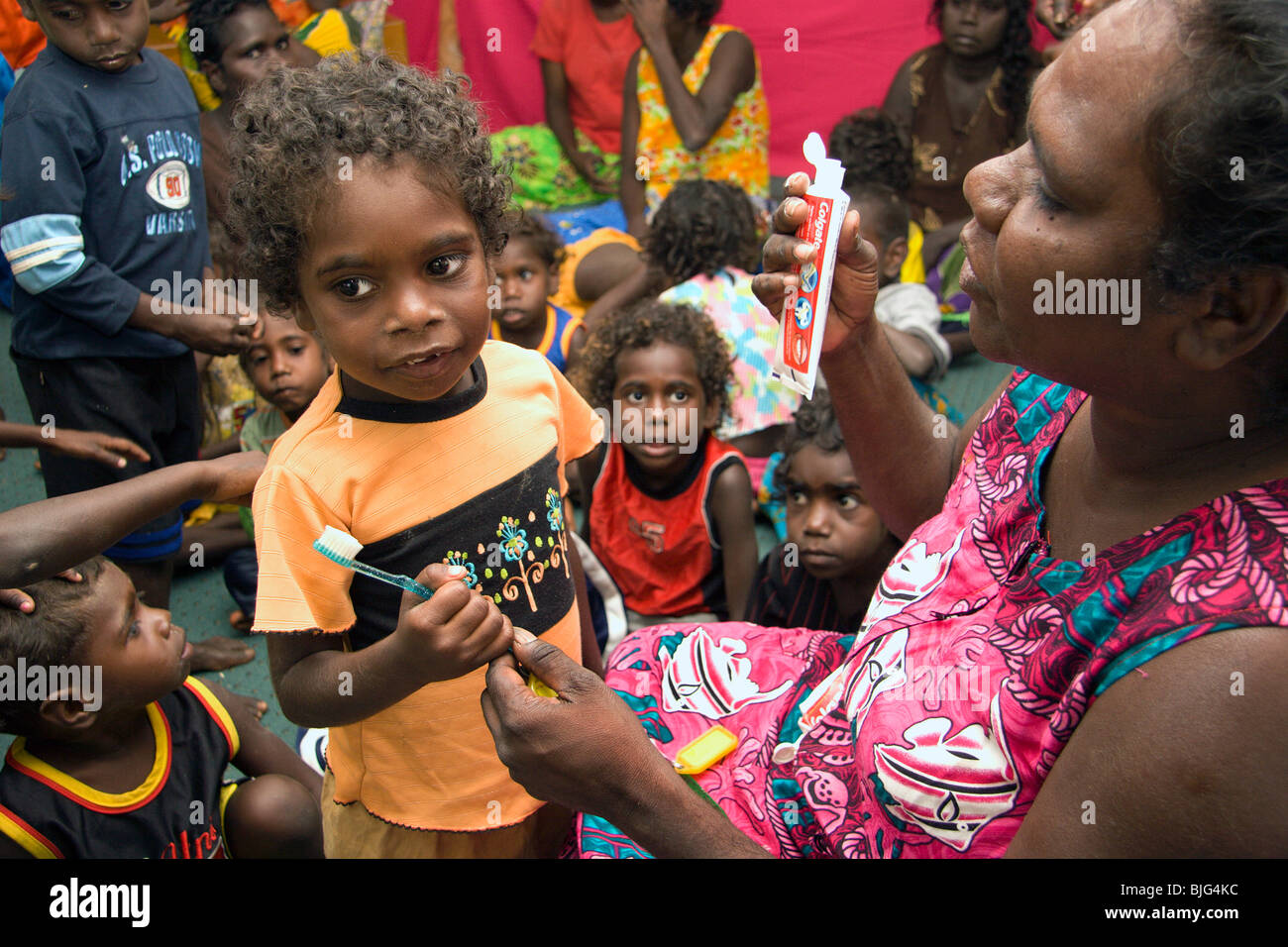 Aboriginal children at Ramingining preschool learning to clean their teeth with brush and toothpaste Arnhem Land Stock Photo