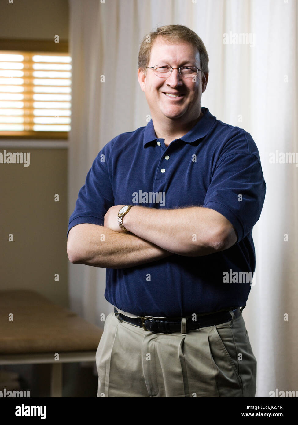 physical therapist standing with arms folded Stock Photo