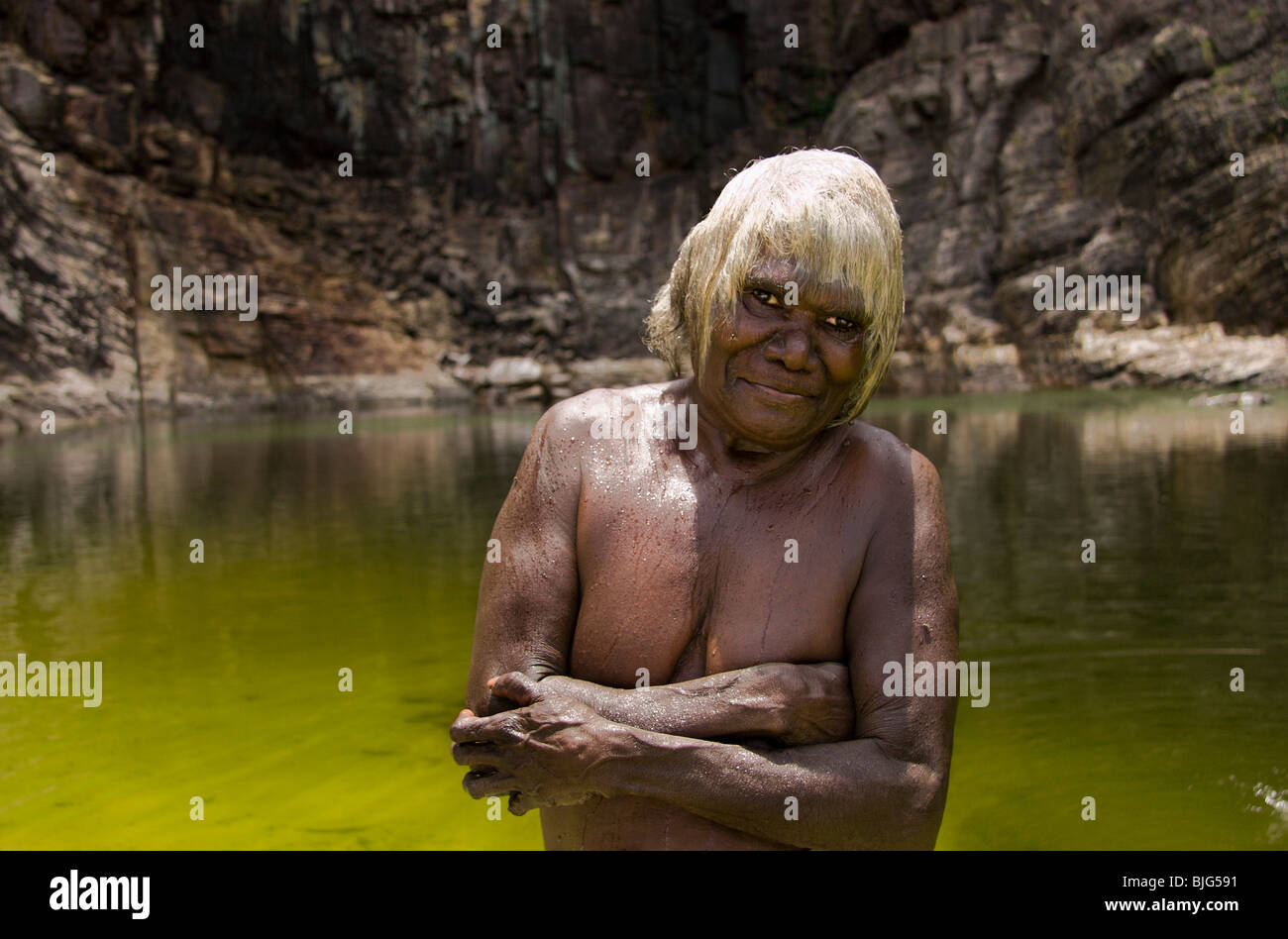 Aboriginal grandmother Roslyn Nyalabidj enjoys a cooling dip at Adjumarrmarl water hole pool Eastern ArnhemLand Stock Photo