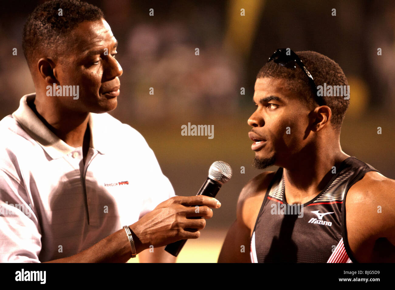 USA's Terrence Trammell being interviewed by Lewis Johnson after winning the Men's 110m Hurdles, finishing in 13.11sec. Stock Photo