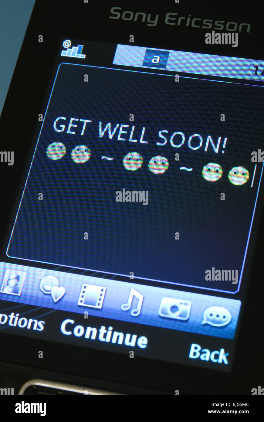 A 'Get well soon' text message on a mobile phone. Stock Photo