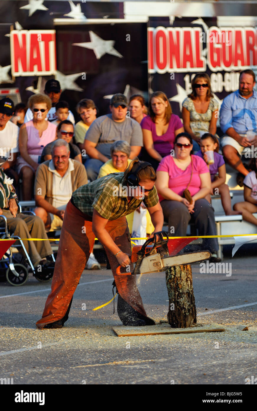 Female Lumberjack Demonstrating Chainsaw Carving at the 2009 Kentucky State Fair in Louisville Stock Photo