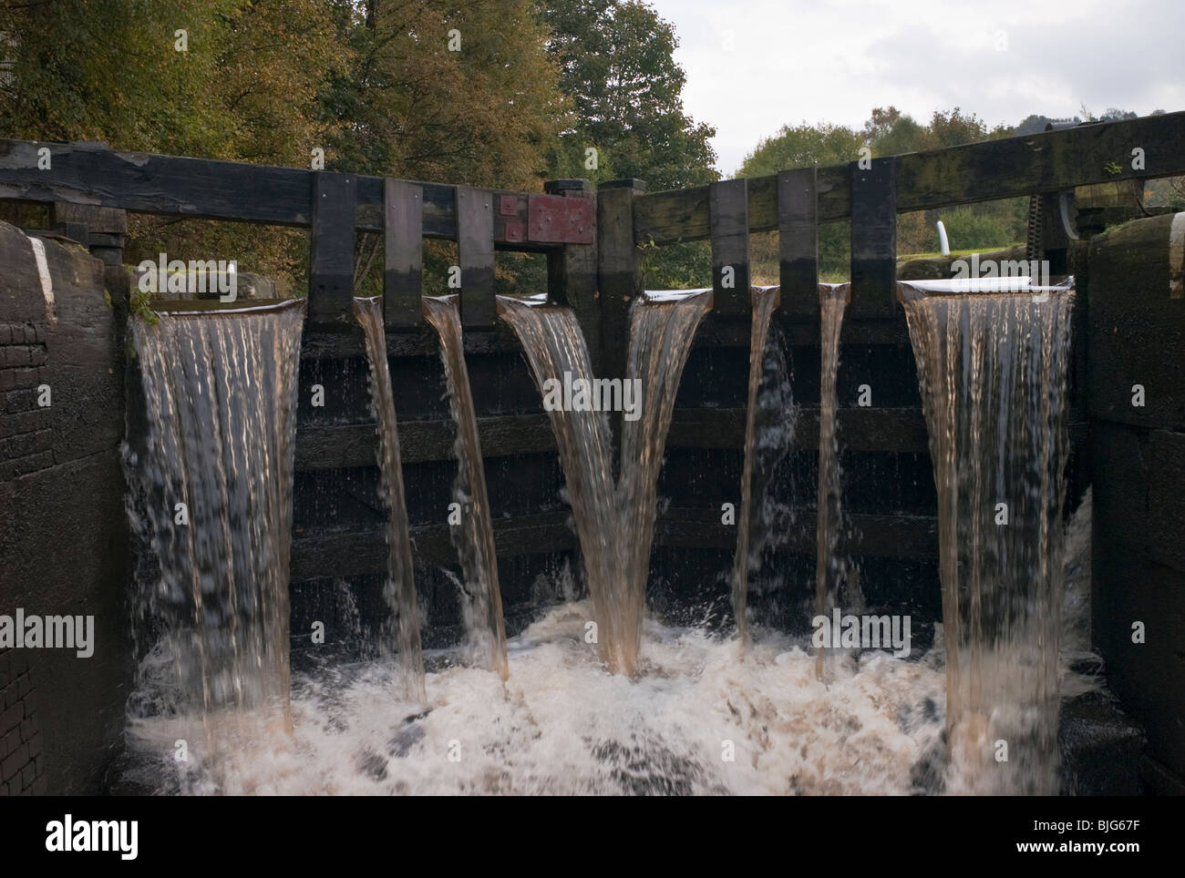 Water cascades through 'overflow' gates of a lock on the Rochdale canal, Yorkshire, UK. Stock Photo