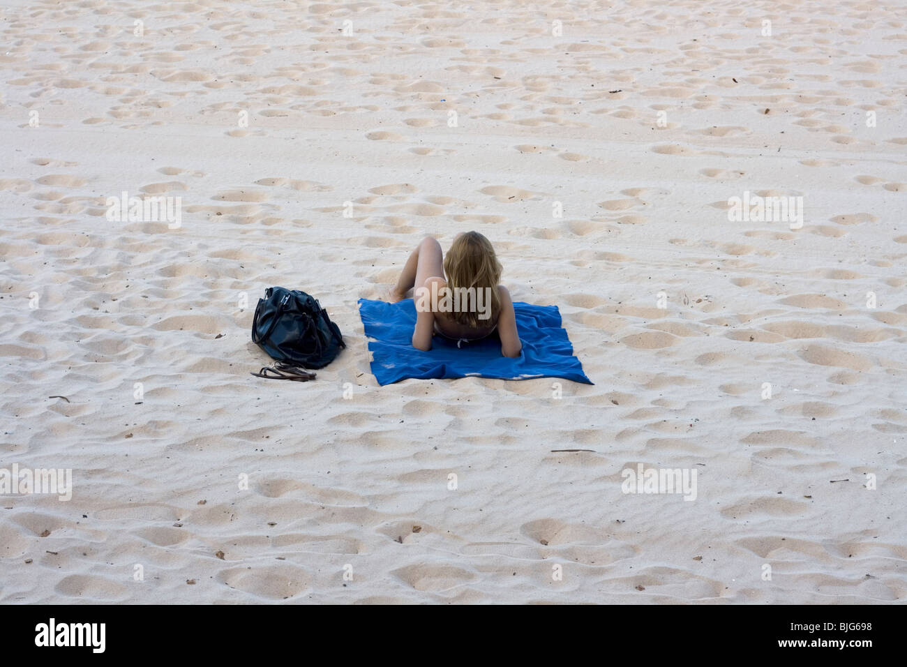 Girl alone on the beach. Stock Photo