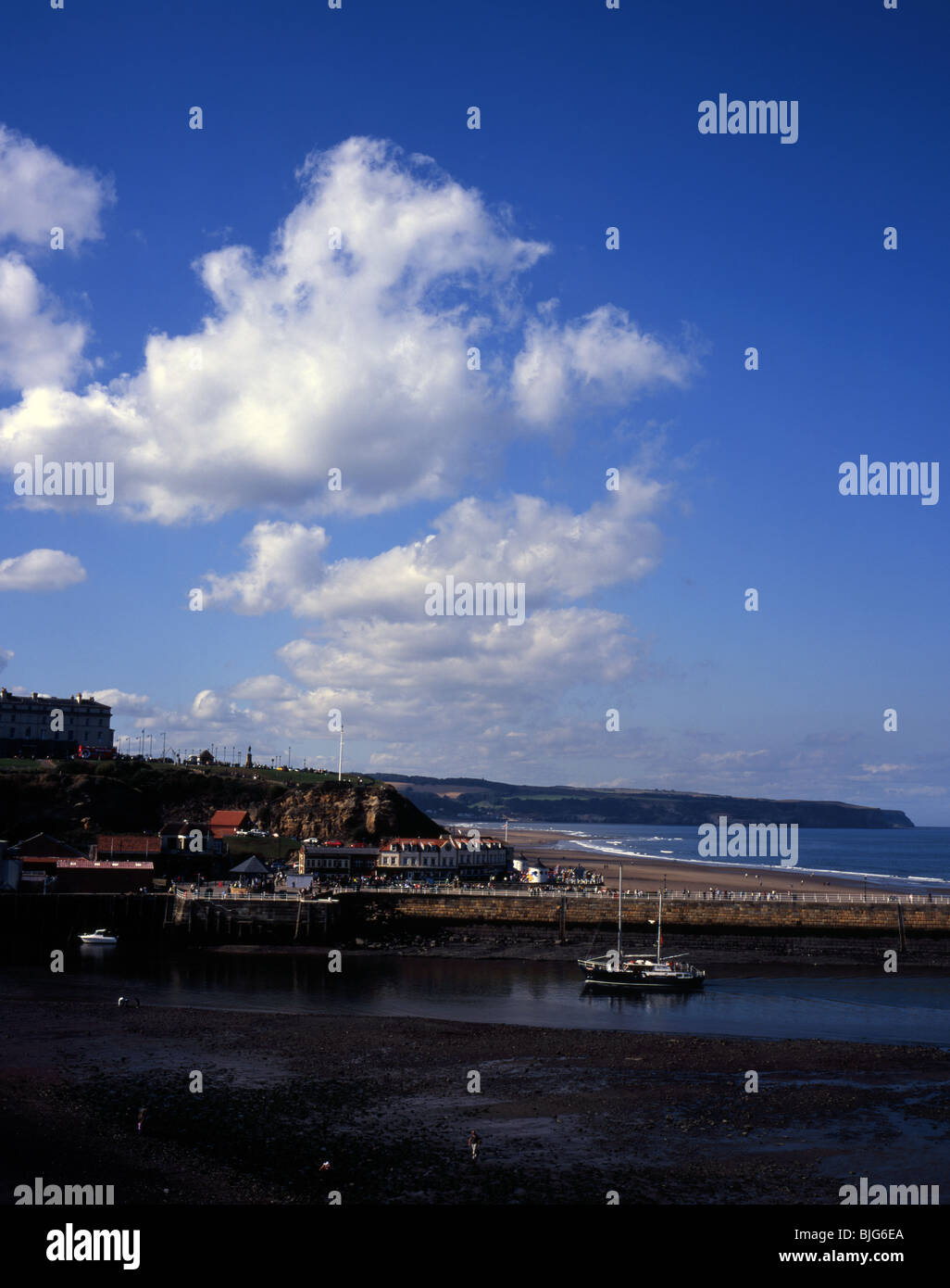 Shops and cafes at the end of Pier Road, sailing boat entering the