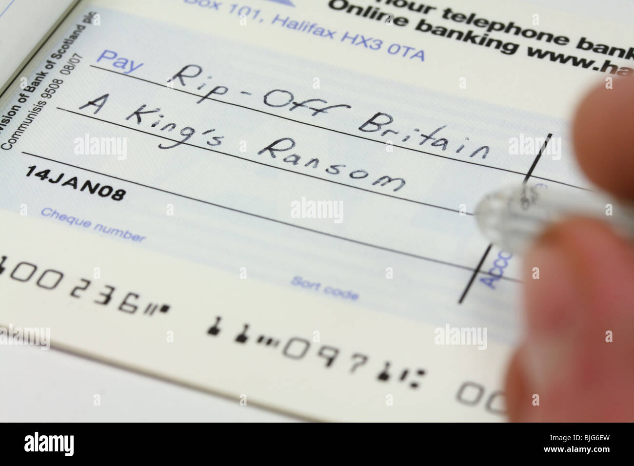 Writing a cheque - 'Rip-off Britain' concept Stock Photo
