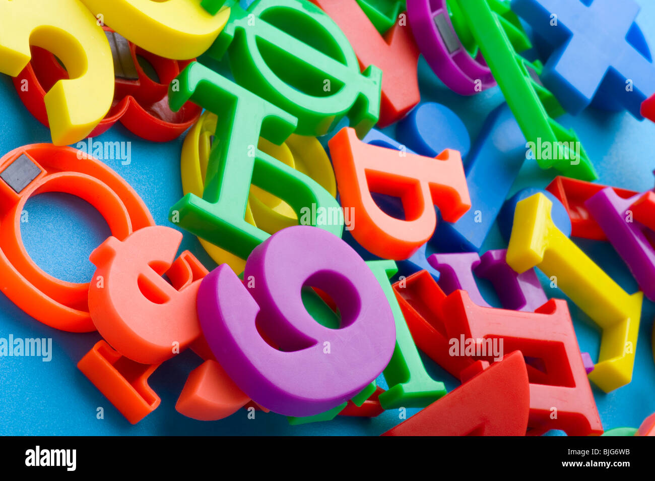 object on blue - toy plastic letters and numbers Stock Photo