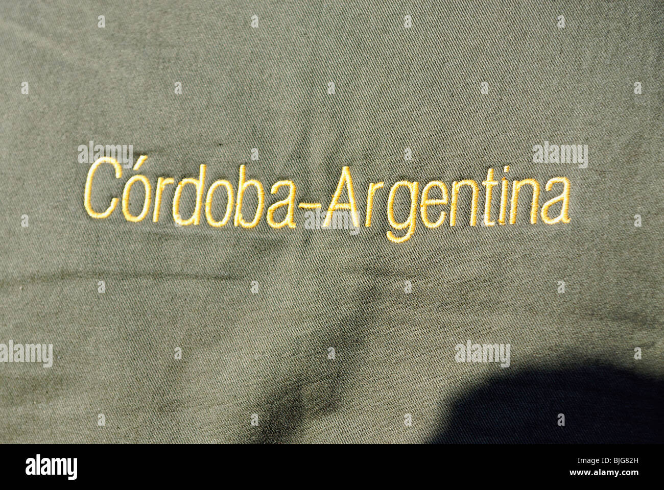 The Words Cordoba, Argentina Embroidered in Gold Thread on Olive Green Material at La Dormida, Lodge in Cordoba, Argentina Stock Photo
