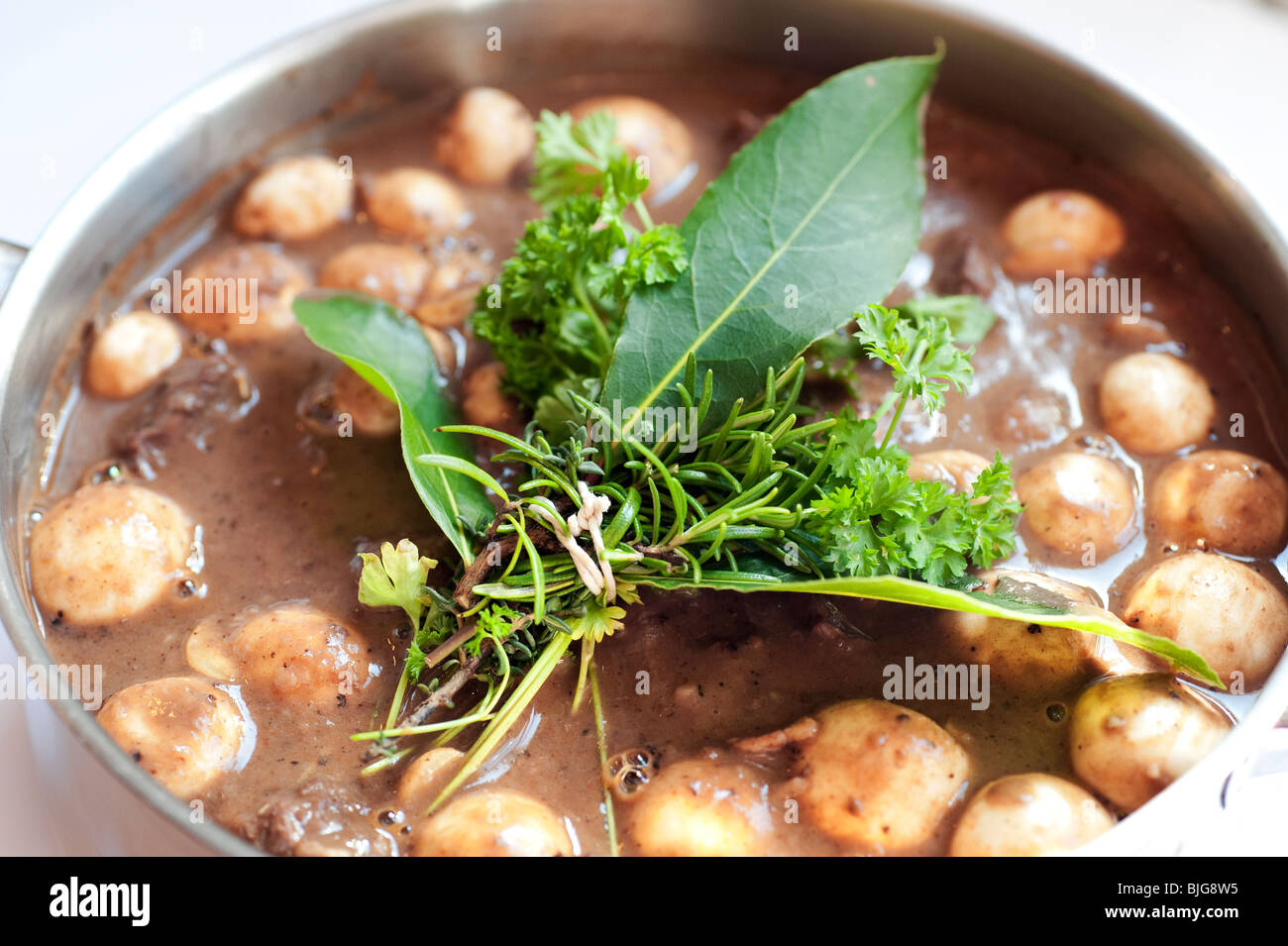 Classic French Boeuf a la Bourguignon Beef Burgundy dish with mushrooms and fresh bouquet garni ready for the oven Stock Photo