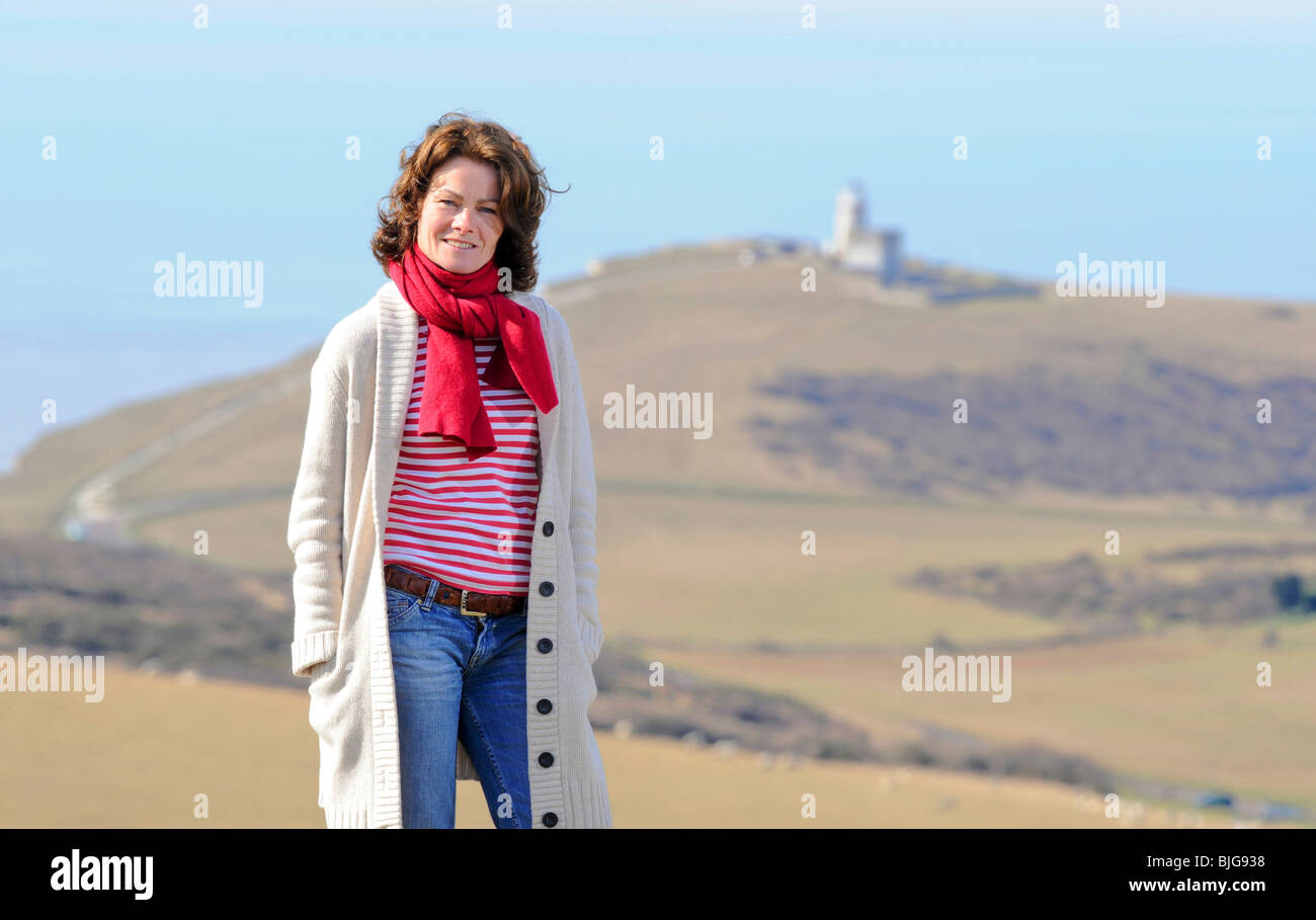 Actress Janet Dibley on the South Downs near Eastbourne and Belle Toute lighthouse East Sussex, UK. Picture by Jim Holden. Stock Photo