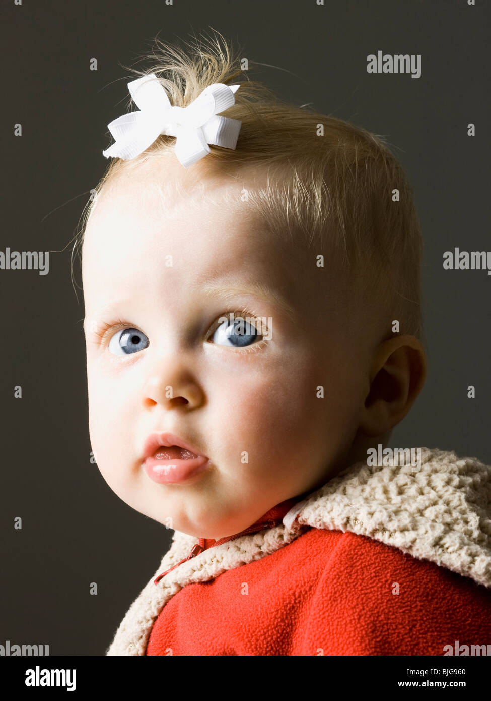 baby girl in a red coat Stock Photo Alamy