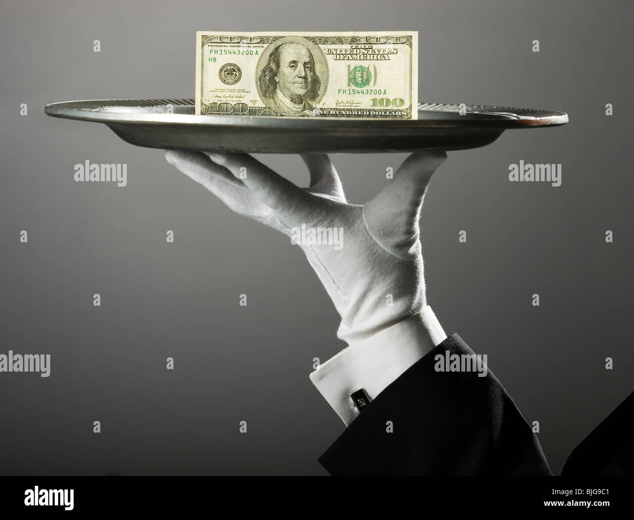 100 dollar bill on a platter Stock Photo