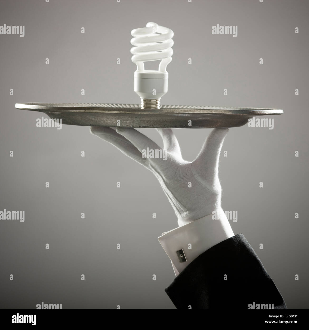 energy saving lightbulb on a platter Stock Photo