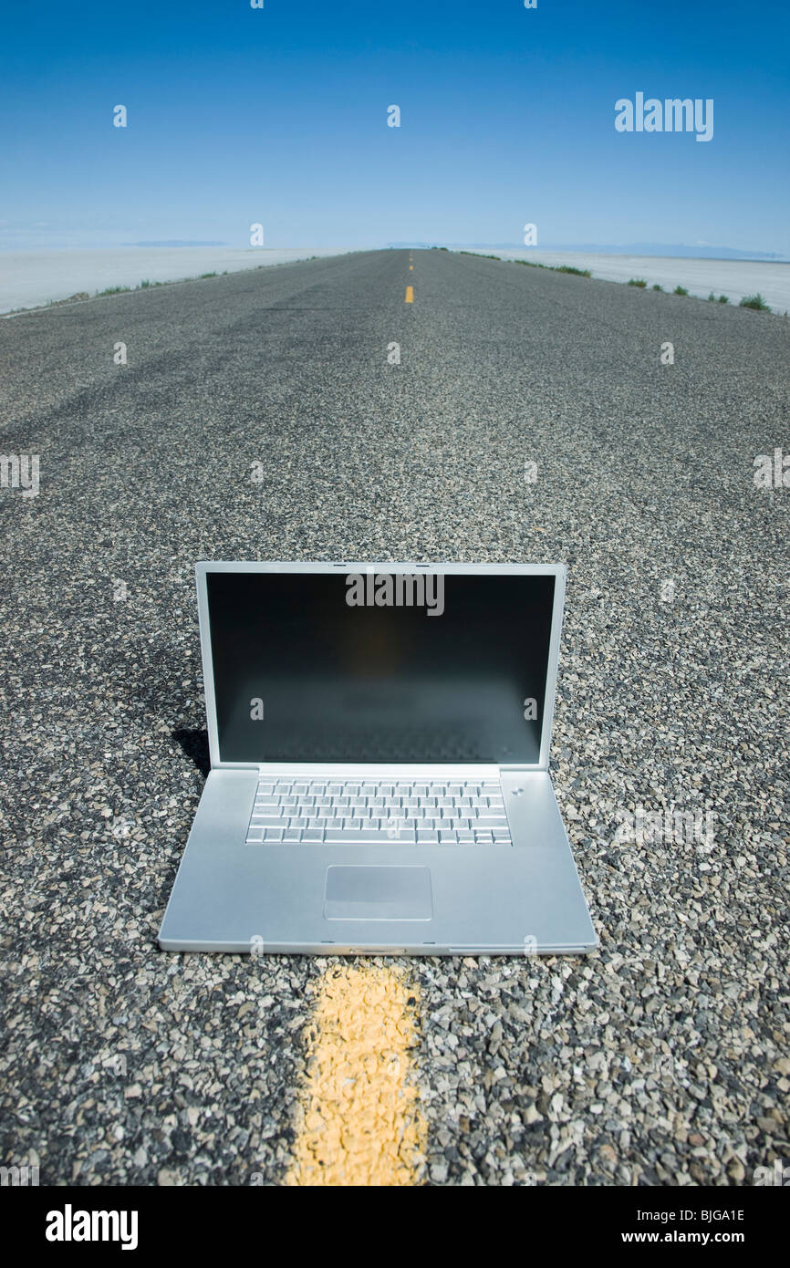 laptop in the middle of the highway Stock Photo