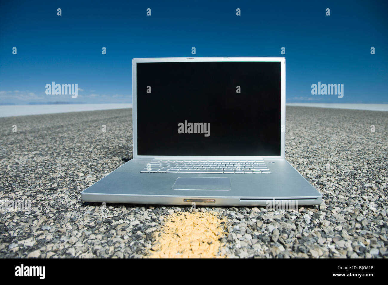 laptop in the middle of the highway Stock Photo