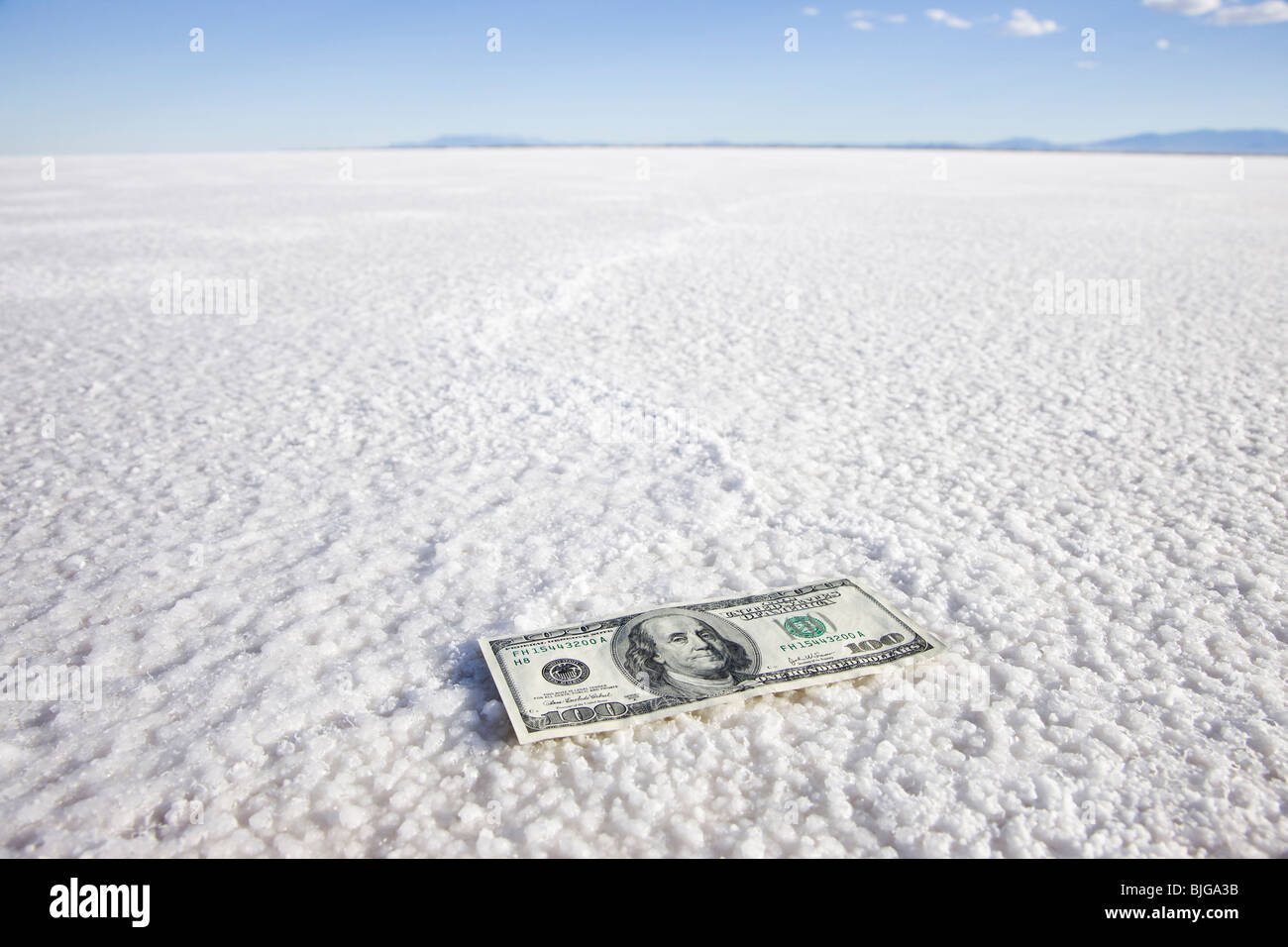 one hundred dollar bill in the middle of nowhere Stock Photo