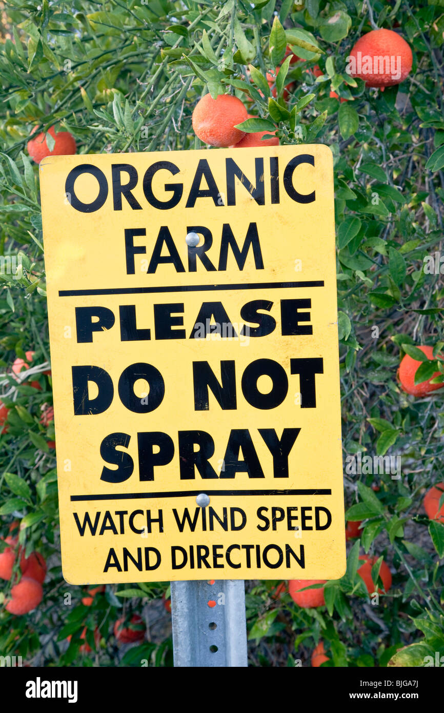 Sign 'Organic Farm, Please Do Not Spray'. Stock Photo